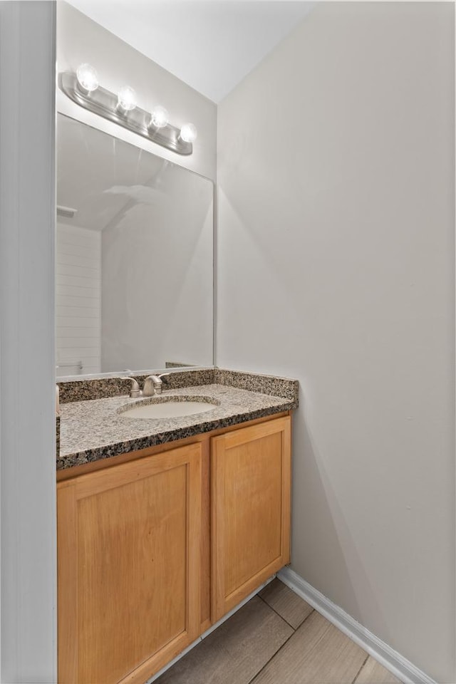 bathroom featuring vanity and baseboards