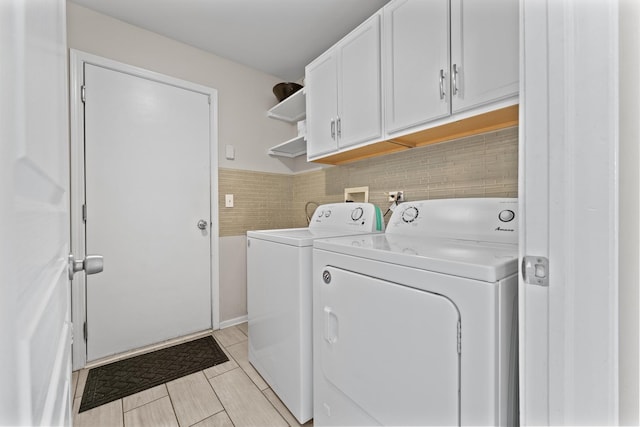 washroom featuring cabinet space and independent washer and dryer