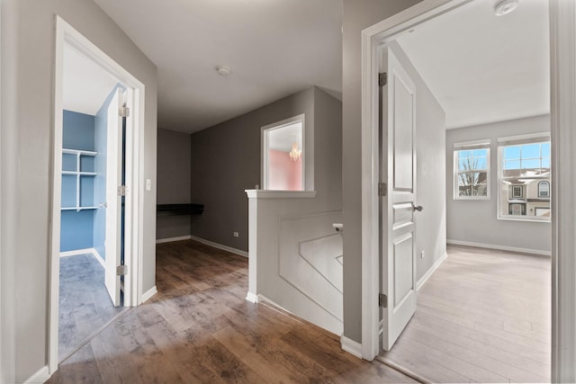 hall featuring baseboards and wood finished floors