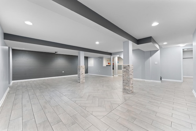 finished basement featuring recessed lighting, baseboards, and parquet flooring