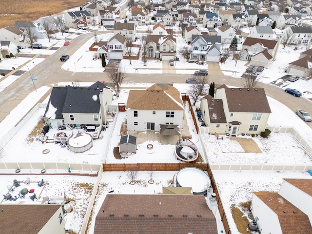 snowy aerial view featuring a residential view