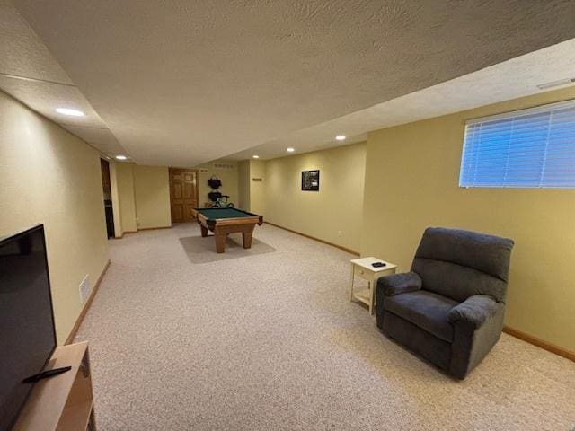 game room with a textured ceiling, billiards, and light carpet