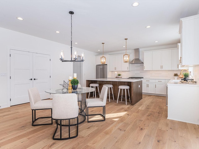 dining area featuring sink and light hardwood / wood-style floors