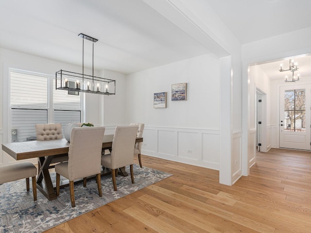 dining room featuring an inviting chandelier and light hardwood / wood-style floors