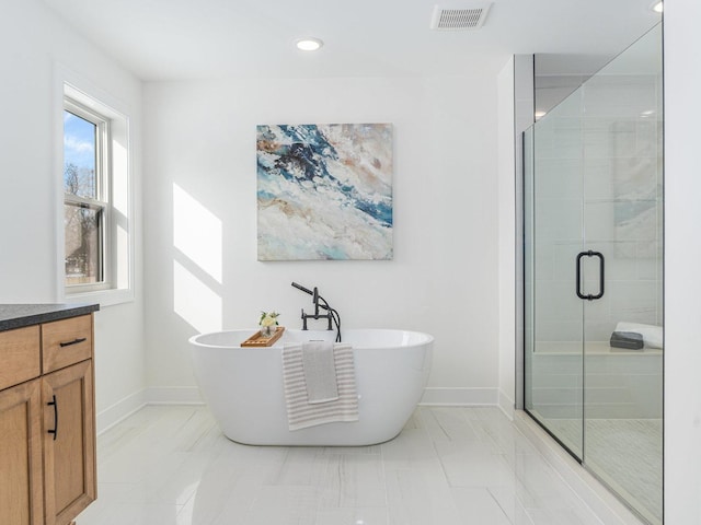 bathroom featuring vanity and plus walk in shower