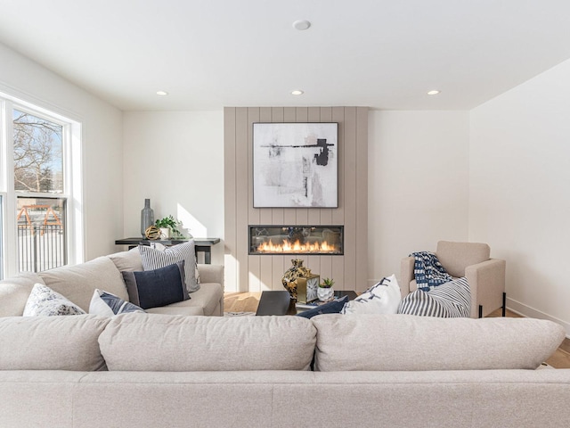 living room featuring a large fireplace