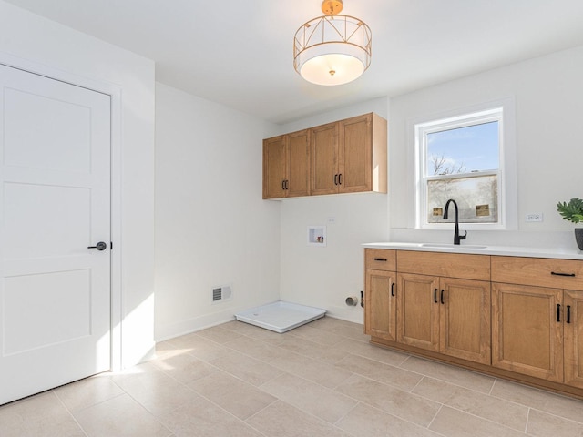 laundry area featuring cabinets, sink, and hookup for a washing machine