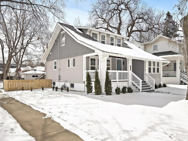 view of front of house featuring covered porch and fence