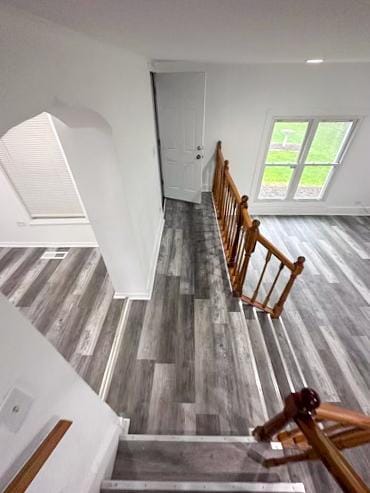 stairway with baseboards and wood finished floors