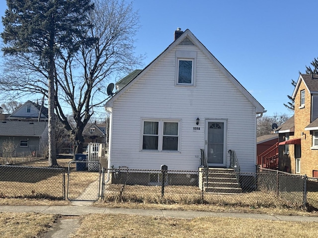 bungalow-style house featuring entry steps, a fenced front yard, and a gate