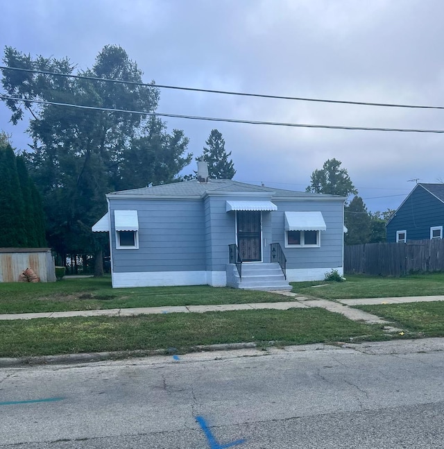 view of front of home with fence and a front yard