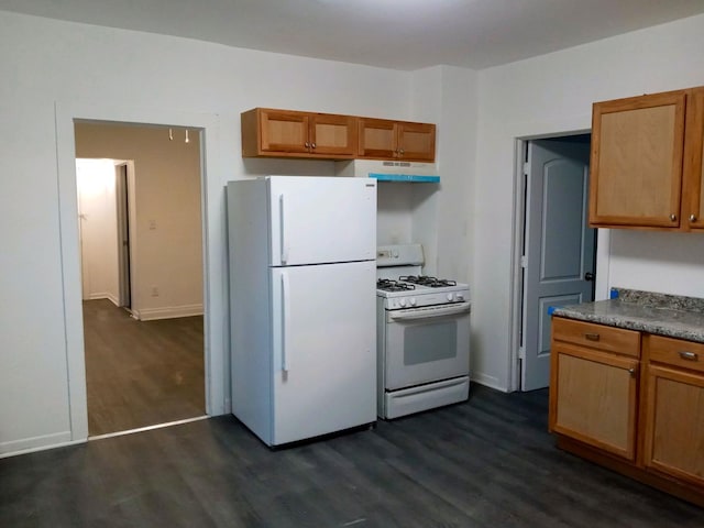 kitchen featuring dark wood-type flooring, white appliances, brown cabinetry, and under cabinet range hood