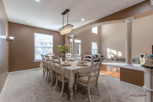 dining area with decorative columns, baseboards, light colored carpet, and recessed lighting