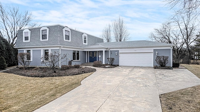 view of front facade with mansard roof, a garage, brick siding, driveway, and a front yard