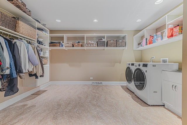 laundry area with cabinet space, recessed lighting, baseboards, and independent washer and dryer