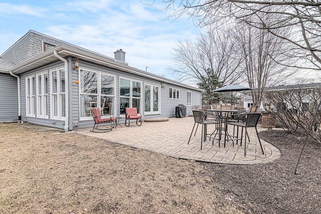 back of house with a chimney, a patio area, and a fenced backyard