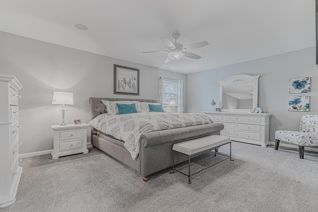 bedroom with light carpet, ceiling fan, and baseboards