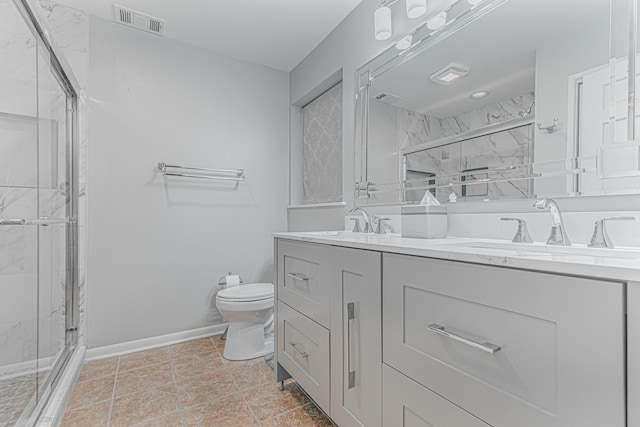 full bath featuring a marble finish shower, double vanity, a sink, and visible vents