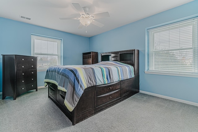 bedroom featuring baseboards, visible vents, and light colored carpet