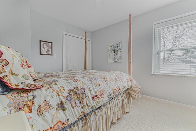 bedroom featuring ceiling fan, carpet floors, a closet, and baseboards