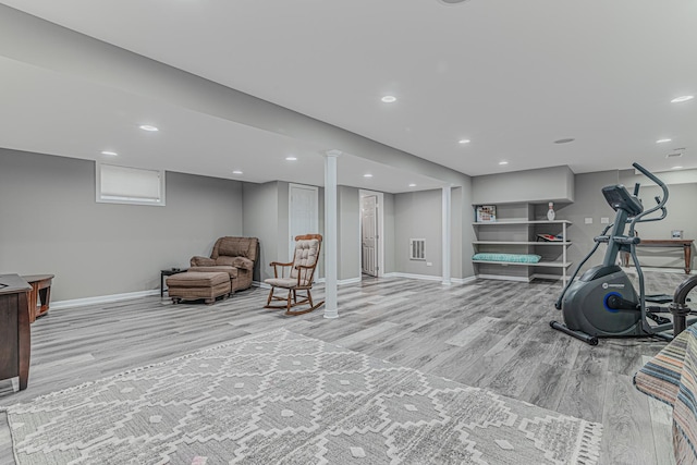 workout area featuring light wood-type flooring, baseboards, and recessed lighting