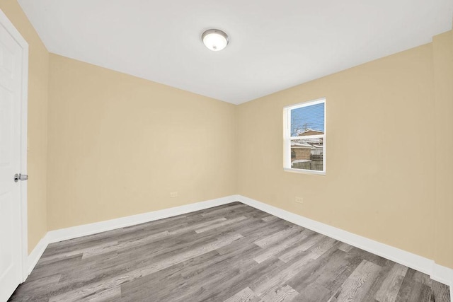 unfurnished room featuring hardwood / wood-style flooring