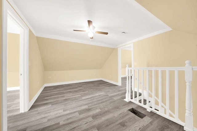 additional living space with hardwood / wood-style floors, lofted ceiling, and ceiling fan