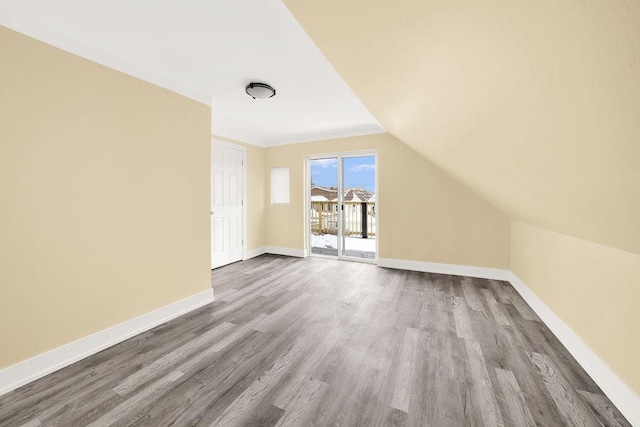 bonus room with vaulted ceiling and hardwood / wood-style floors