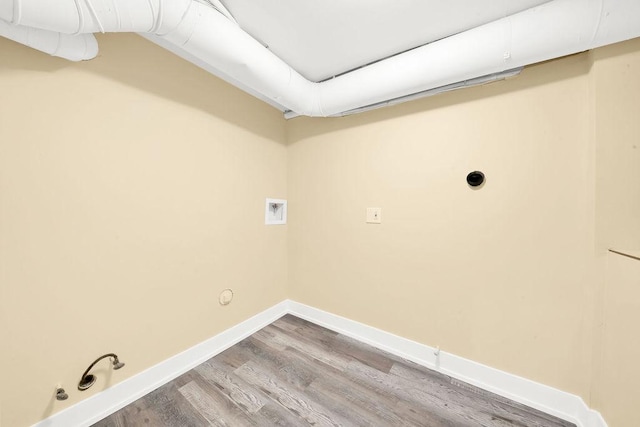 clothes washing area featuring washer hookup, hardwood / wood-style flooring, hookup for an electric dryer, and gas dryer hookup