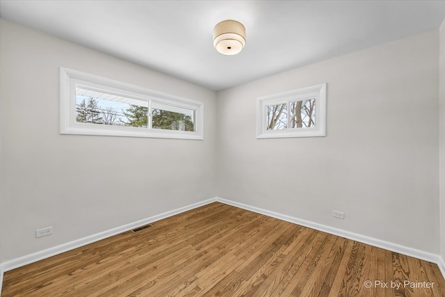 unfurnished room with a healthy amount of sunlight and baseboards