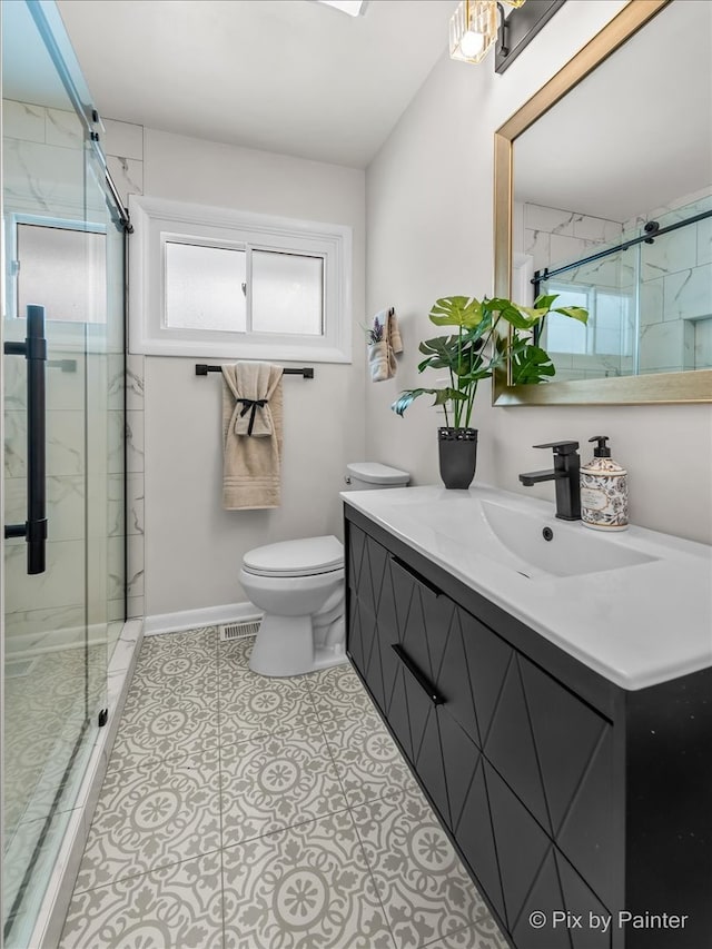 full bath featuring a marble finish shower, baseboards, visible vents, toilet, and vanity