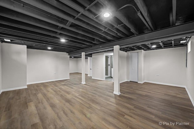 finished basement with baseboards and wood finished floors