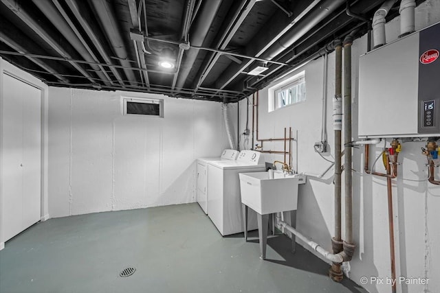 basement with washing machine and dryer and a sink