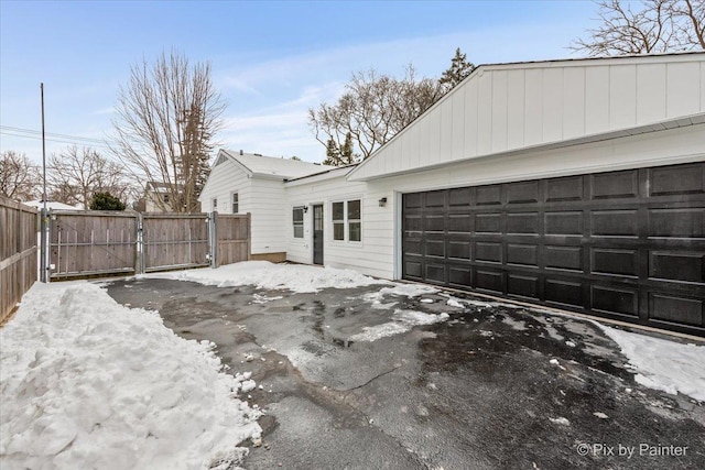 exterior space featuring a gate, fence, and driveway