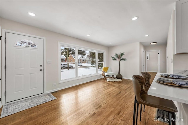 entryway featuring light wood-style flooring, baseboards, and recessed lighting