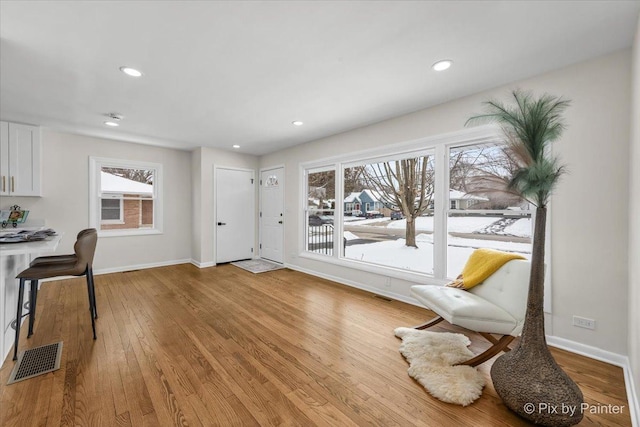 interior space featuring recessed lighting, baseboards, visible vents, and light wood finished floors