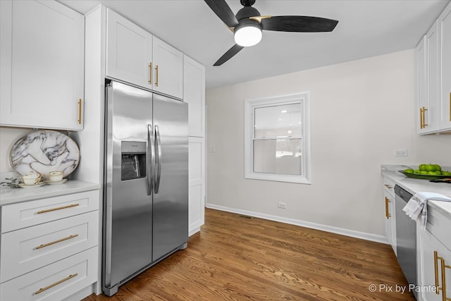 kitchen featuring stainless steel appliances, wood finished floors, baseboards, white cabinets, and light countertops