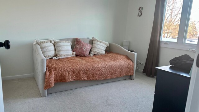 carpeted bedroom featuring baseboards
