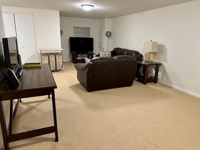 living area with baseboards and light colored carpet