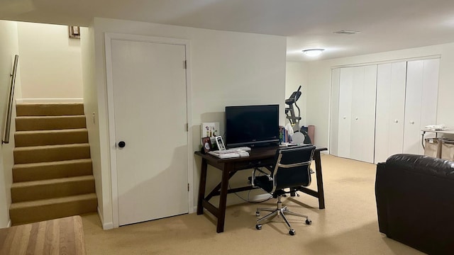 office area featuring light colored carpet