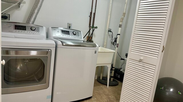 clothes washing area with laundry area and washer and dryer