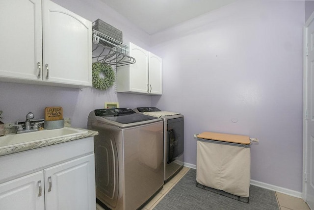 3642 Monarch Cir, Naperville, IL 60564 - clothes washing area featuring cabinet space, light tile patterned floors, a sink, baseboards, and washer and dryer