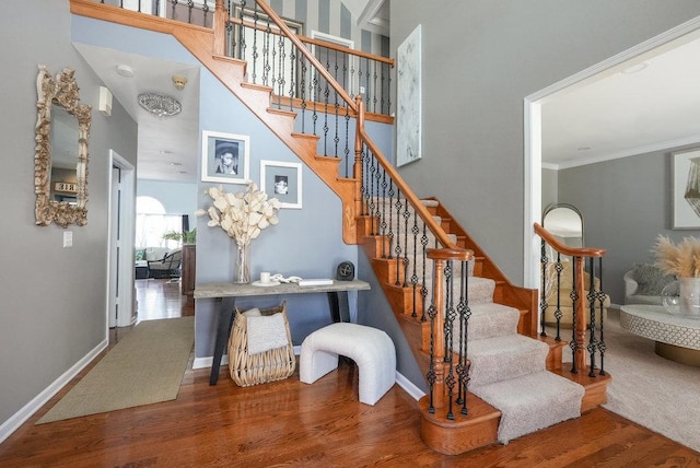3642 Monarch Cir, Naperville, IL 60564 - staircase with crown molding, baseboards, a high ceiling, and wood finished floors