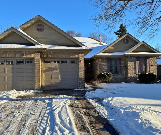 craftsman-style house with a garage and brick siding