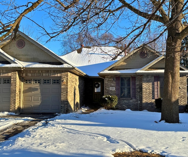 view of front of property with a garage and brick siding