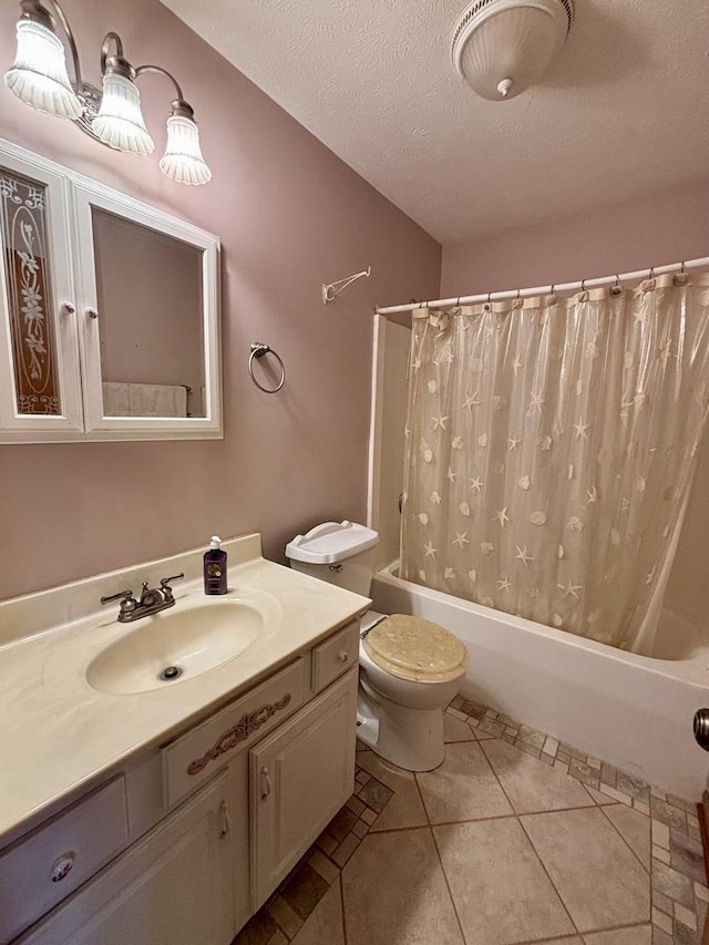 full bath with a textured ceiling, tile patterned flooring, toilet, shower / tub combo, and vanity