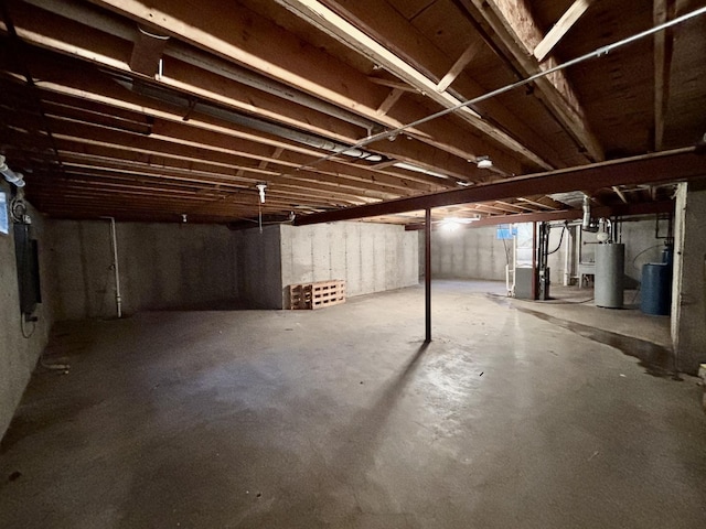 unfinished basement featuring gas water heater