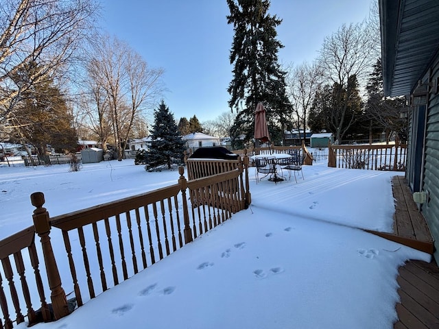 snowy yard featuring a deck