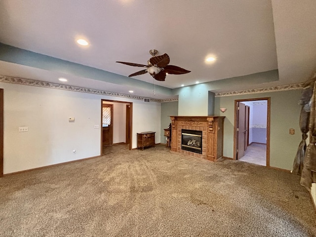 unfurnished living room featuring ceiling fan, recessed lighting, light colored carpet, a fireplace, and baseboards