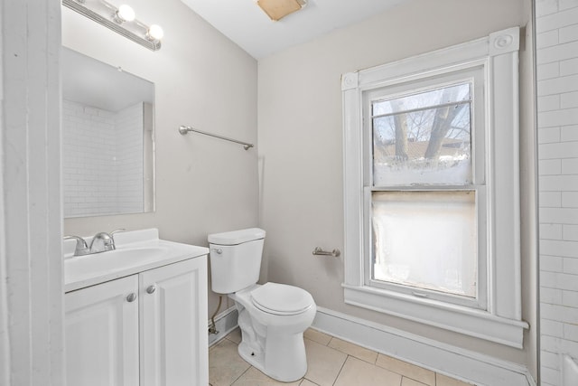 full bathroom featuring toilet, tile patterned flooring, baseboards, and vanity